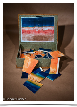 Box with Monotype cut into a puzzle